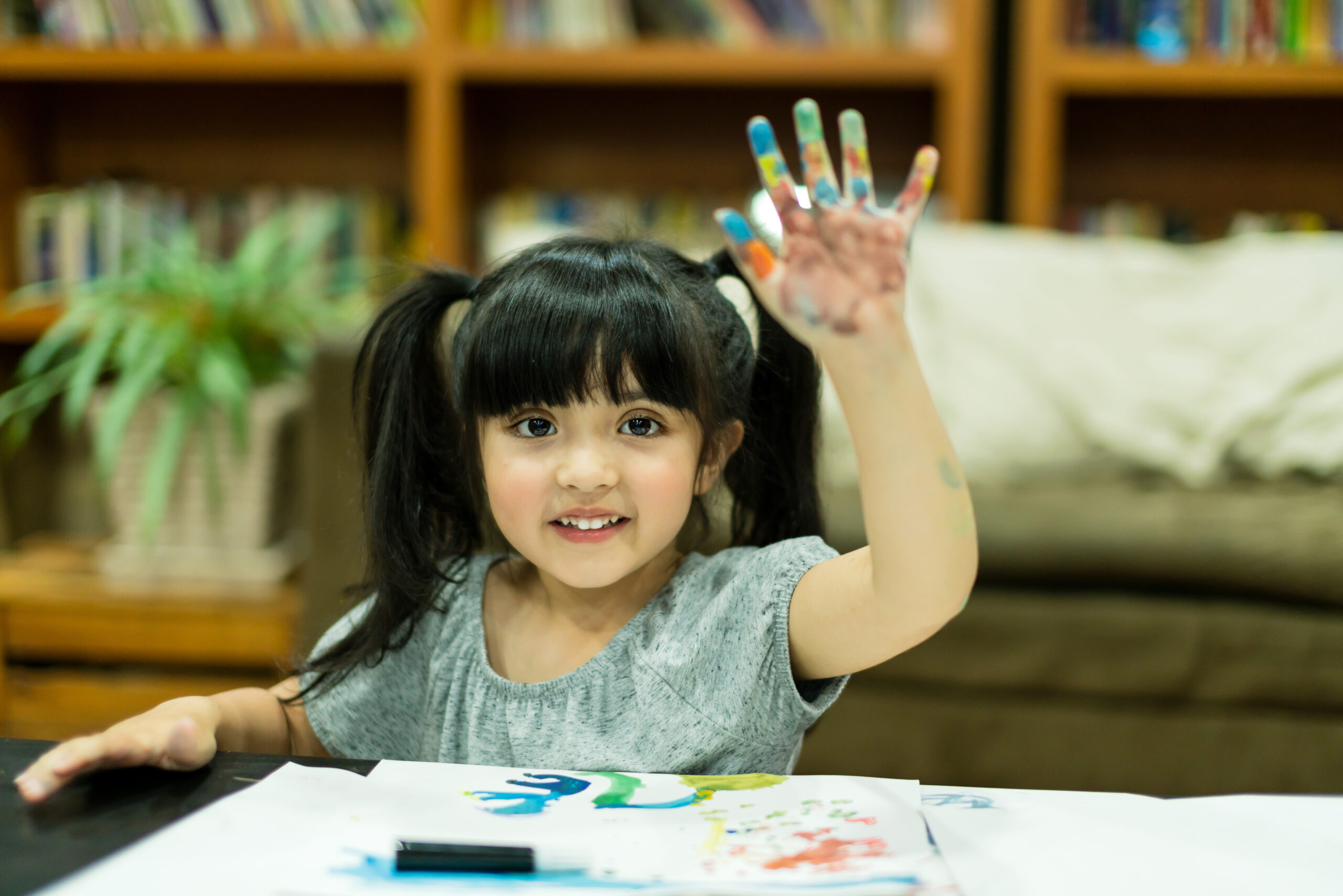 Parents visiting an early learning center to choose the right preschool for their child.